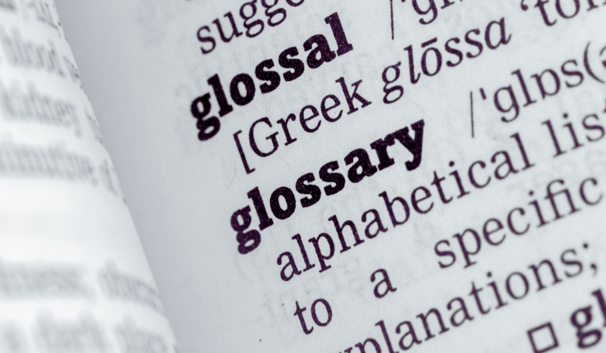 close up of the dictionary definition of glossary - an alphabetical list of terminology