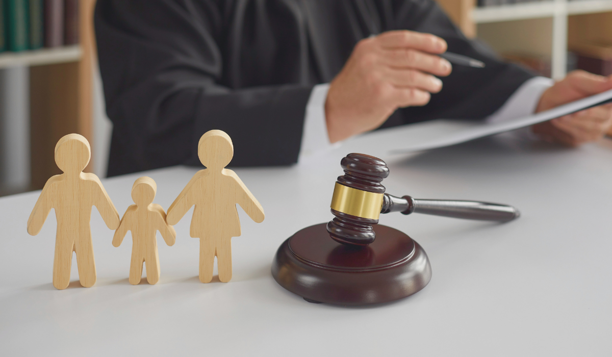 photo of a judge and gavel, with figures representing a child and two adults