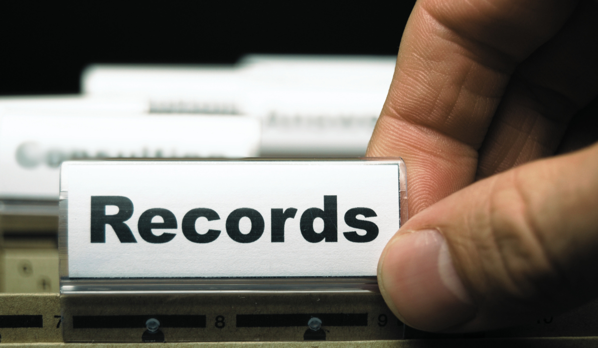 a hand next to a folder that says RECORDS