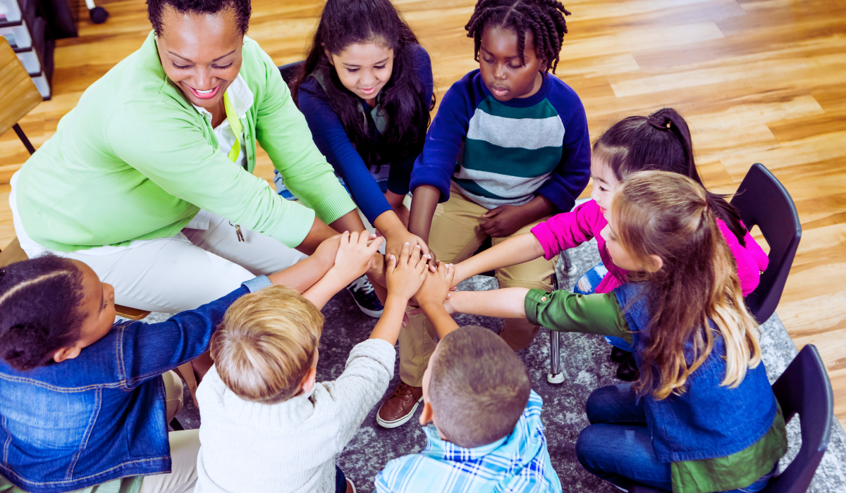 Elementary school teacher and children work together