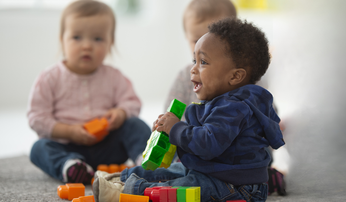 picture of two babies playing with blocks